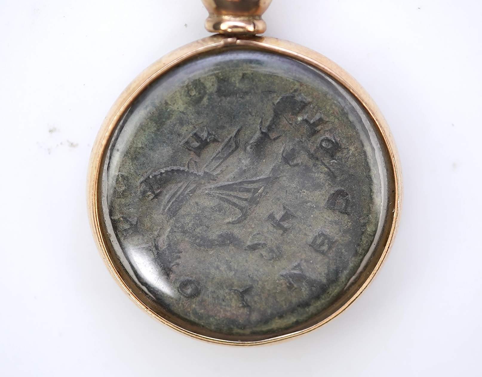 A gold and Roman bronze coin pendant